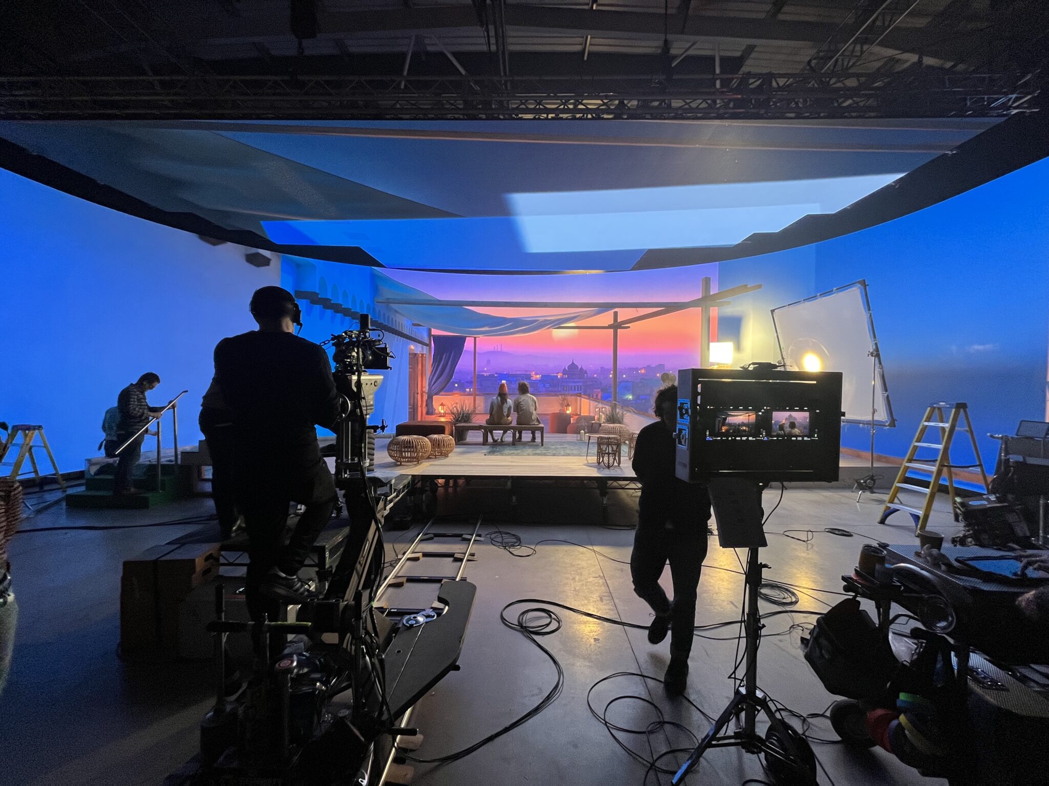 LED volume virtual production stage with crew filming